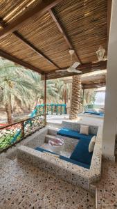 an outdoor patio with a couch and a table at Casa Blanca - calm space for soul revival in Ādam