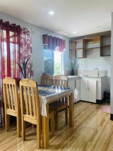 a kitchen with a dining room table and chairs at 2K2M Rental Units in Panglao