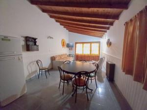 a kitchen and dining room with a table and chairs at Complejo Antilhue in Las Grutas