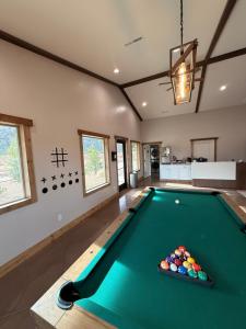a room with a pool table in a house at Gooseberry Lodges Zion National Park Area in Apple Valley