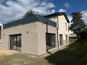 a white house with a balcony on top of it at Modern house 4 bedrooms in Tassin-la-Demi-Lune +5 photos