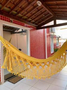 a large yellow hammock hanging from a building at Apt aconchegante perto do shopping in Petrolina