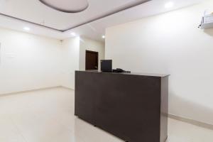 an office with a black podium in a white room at Hotel O Shannu Residency in Secunderabad