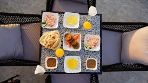 a breakfast tray with eggs and food on it at Princess Pyramids View Inn in Cairo