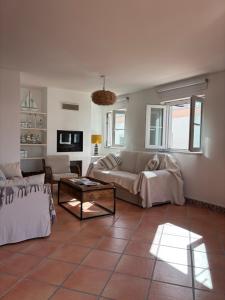 a living room with a couch and a table at Ria Seahouse Cabanas de Tavira in Tavira