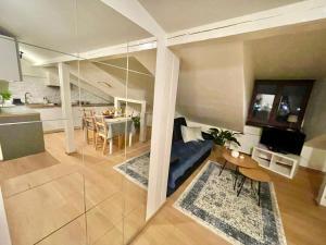 a large room with a kitchen and a dining room at Apartament na Starówce in Zamość