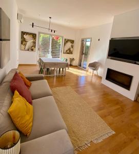 a living room with a couch and a table at Skydiversnestdotcom in Bollullos de la Mitación