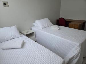 two beds sitting next to each other in a room at Condominio Delville 2 quartos in Porto Velho +3 photos