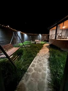 a pathway leading to a house at night with lights at Shahdag Berghoff House in Qusar