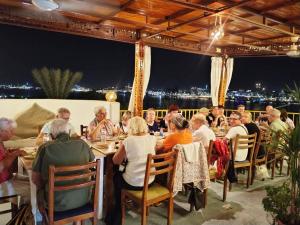 a group of people sitting at tables in a restaurant at Spring Hotel Luxor in Luxor