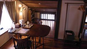 a dining room with a table and chairs and a window at Machiya Club Honkan in Omihachiman +26 photos