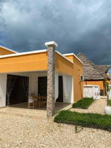 a house with a patio in front of it at DADA GARDEN NUNGWI Private villas in Nungwi +47 photos