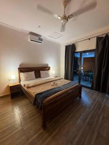 a bedroom with a large bed in a room at DADA GARDEN NUNGWI Private villas in Nungwi