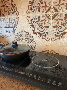 a frying pan sitting on top of a stove at DADA GARDEN NUNGWI Private villas in Nungwi
