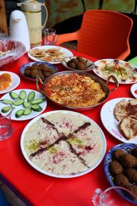 a table with plates of food on a red table at Extra Traveller in Aqaba