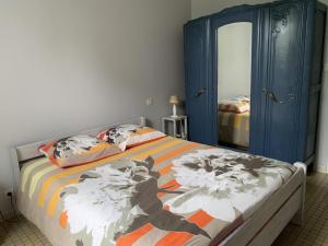 a bedroom with a bed and a blue cabinet at A lines in Montsoué