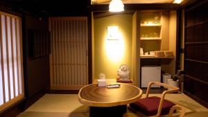 a room with a table and a chair and a lamp at まちや倶楽部別館 in Omihachiman +30 photos