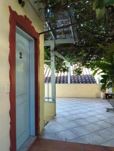 an open door to a building with a patio at kitnet xixo 02 in Gramado