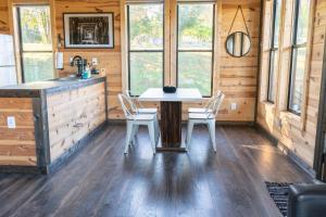 a dining room in a log cabin with a table and chairs at Bourbon Barrel Cottages #5 on Ky Bourbon Trail in Lawrenceburg +7 photos