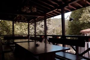 a table and chairs in a room with a view at Къща за гости Орешака in Oreshak +18 photos