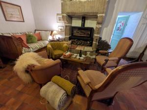 a living room with a couch and a fireplace at La Jeannette in Vains