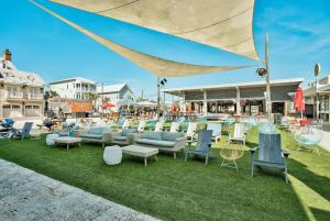 a group of chairs and tables on the grass at Prominence Southside - Blue Skies in Watersound Beach