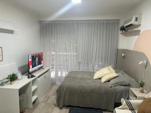 a bedroom with a bed and a television in it at Monoambiente lujoso en Cañitas! in Buenos Aires