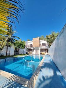 a swimming pool in front of a house at Le Mirage GT in Taxisco