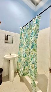 a shower curtain in a bathroom with a sink at Le Mirage GT in Taxisco