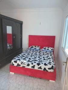 a bedroom with a black and white cow print bed at Résidence Tunis Carthage in Ariana