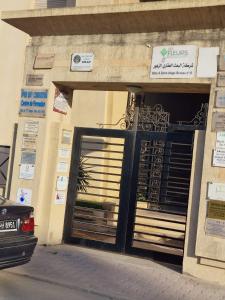 a car parked in front of a building with a garage at Résidence Tunis Carthage in Ariana