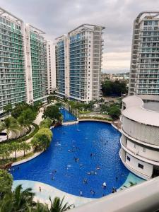 an aerial view of a resort swimming pool with tall buildings at Casa Nimisha Suites-Azure in Manila