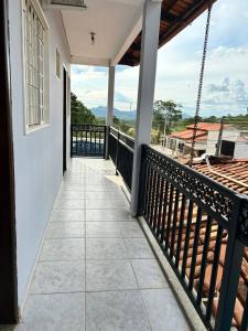 a balcony with a view of the mountains at Pousada Cantinho da Jú in Pirenópolis