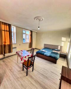 a bedroom with a bed and a table at Rova Hostel in Baku