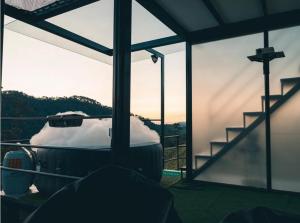 a room with a view of a mountain through a window at Glamping La Maestranza con desayuno incluido in Villamaría