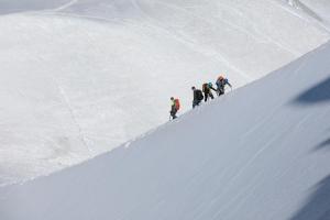a group of people walking up a snow covered slope at l'Ours Bleu A35 - Ski in Ski out - Happy Rentals in Vallorcine