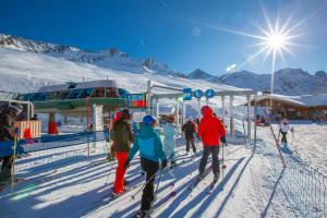 a group of people on skis at a ski lift at l'Ours Bleu A35 - Ski in Ski out - Happy Rentals in Vallorcine
