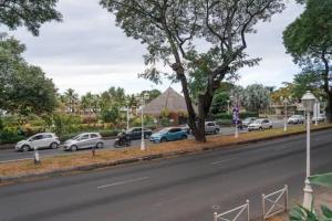 a line of cars parked on the side of a road at Studio Teava in Papeete