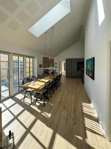 a large dining room with a long table and chairs at Holiday Home With Courtyard In Lille Skagen in Skagen