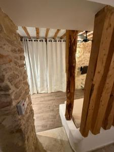 a room with a stone wall and a window at Casa Dea - Bungalow Aphrodite in Hammamet Sud