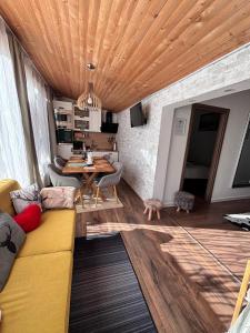 a living room with a couch and a table at Cazare La Luiza b in Şura Mare