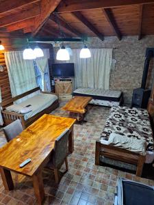 a living room with wooden tables and a couch at Quinta El Zorzal in La Unión +10 photos