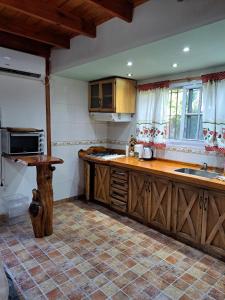 a kitchen with wooden cabinets and a counter top at Quinta El Zorzal in La Unión