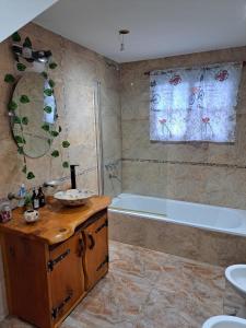 a bathroom with a bath tub and a sink at Quinta El Zorzal in La Unión