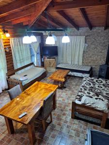 a living room with wooden tables and a room with a bed at Quinta El Zorzal in La Unión