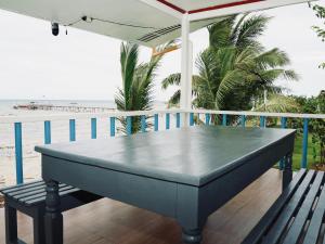 a blue table on a balcony with the beach at Jlb resort and tours,Guest House in Valdez