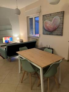a dining room with a wooden table and chairs at Casa Cuore Mother Ross in Ariano Irpino