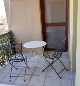 a white table and two chairs on a patio at Promenada Mall Apartment4you in Craiova +5 photos