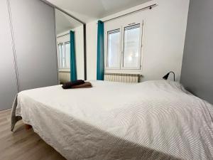 a large white bed in a room with two windows at Villa la Casa in Montauroux +21 photos