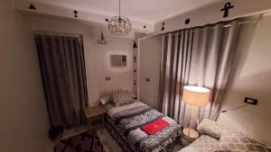 a living room with a bed and a lamp at Horus key Nile View in Aswan +35 photos